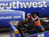 A Southwest Airlines vai cobrar pela primeira vez pelo despacho de bagagens e lançará bilhetes de classe econômica básica Funcionários de operações terrestres carregam bagagens em uma aeronave Boeing 737 da Southwest Airlines na pista do Aeroporto John Wayne, em Santa Ana, Califórnia.